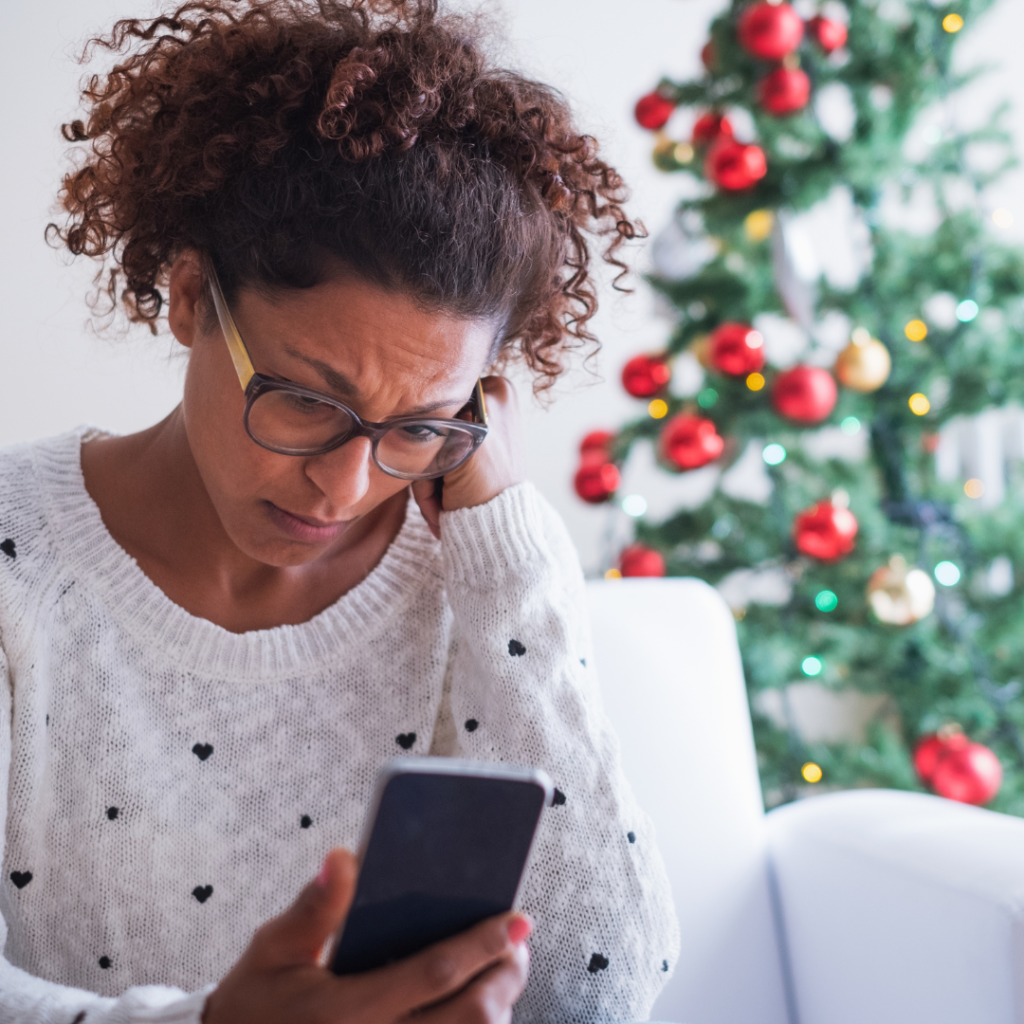 Worried mixed race woman at home on christmas holiday