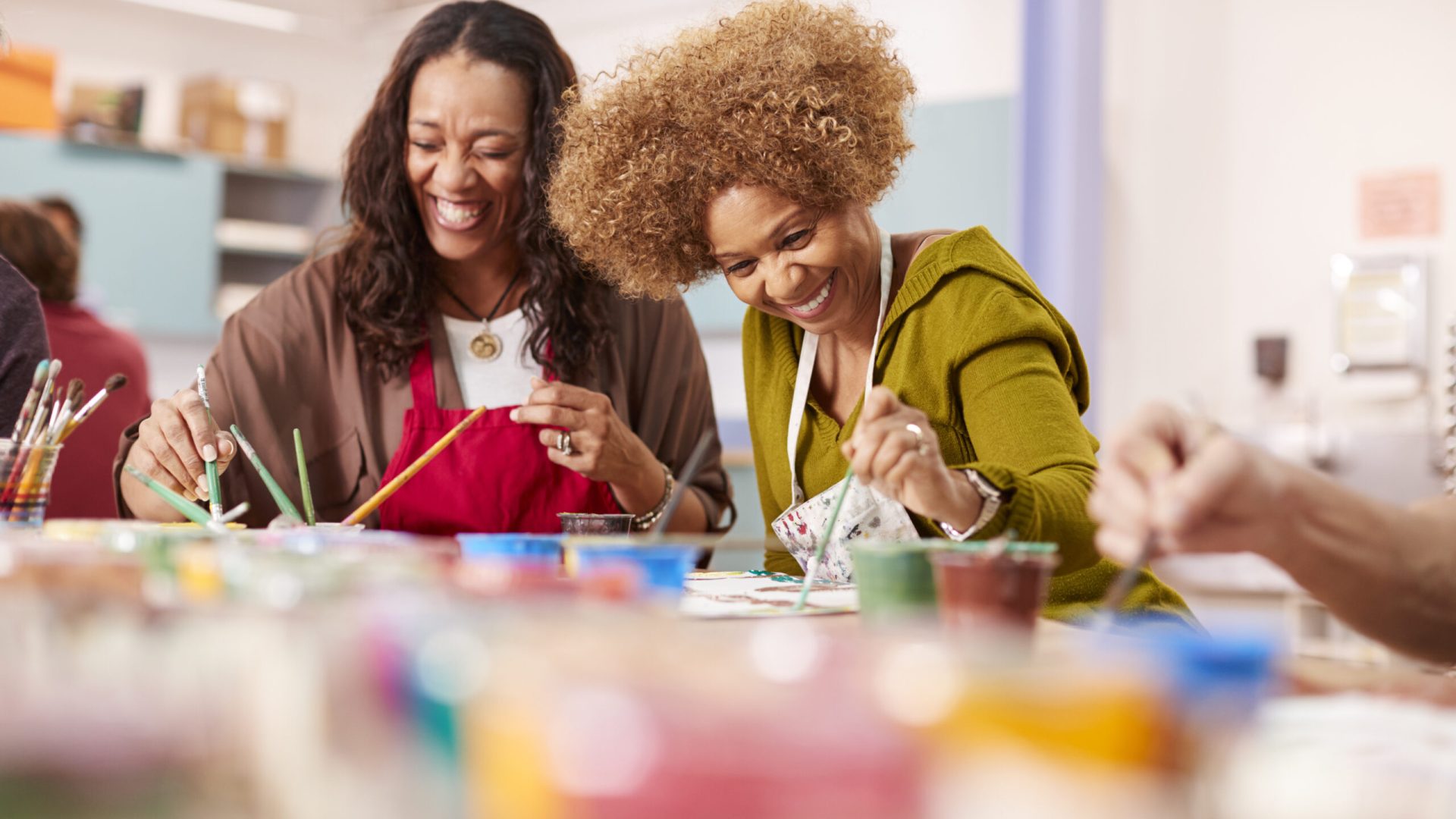 Two Mature Women Attending Art Class In Community Centre Together